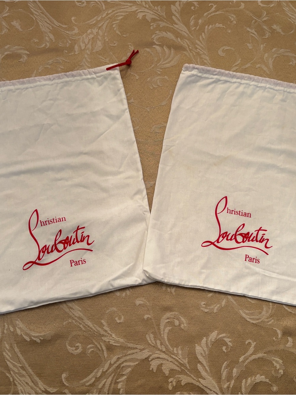 Christian Louboutin White Dust Bags with Red Logo - Set of Two

Stain on a bag.